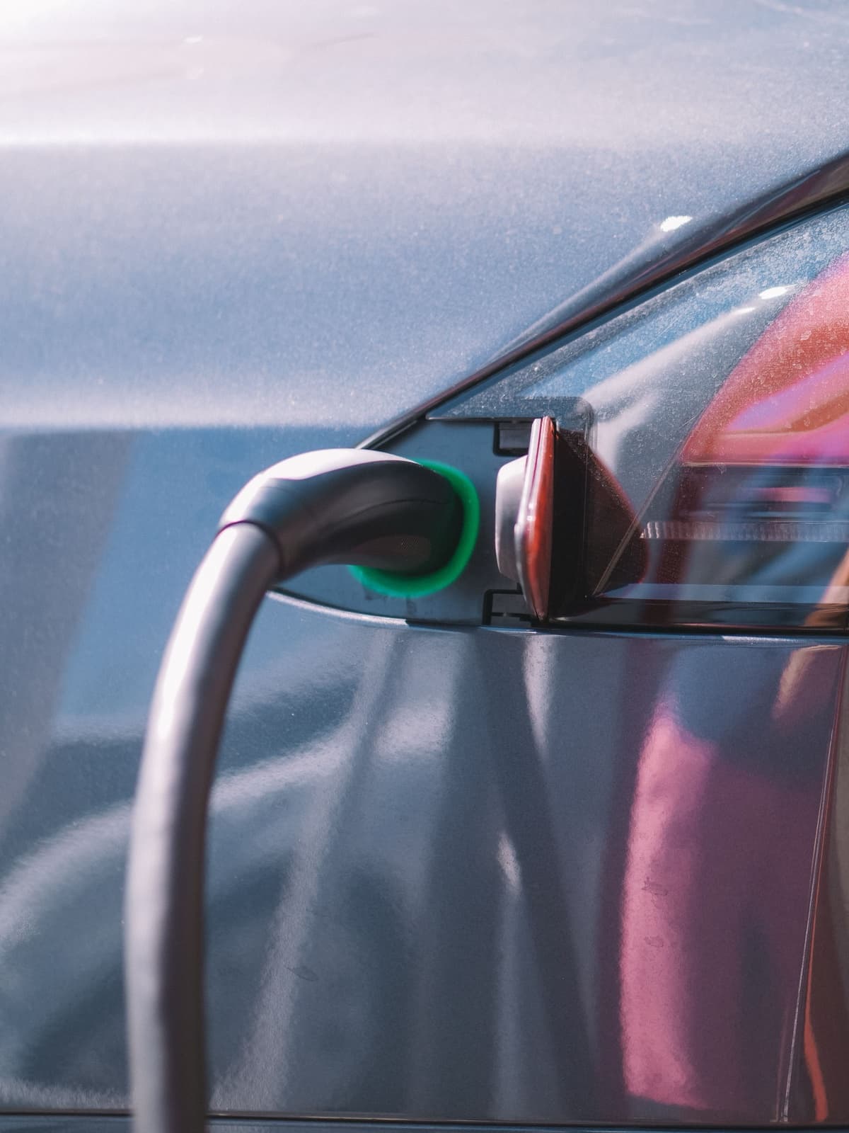 EV charging cable plugged into a car