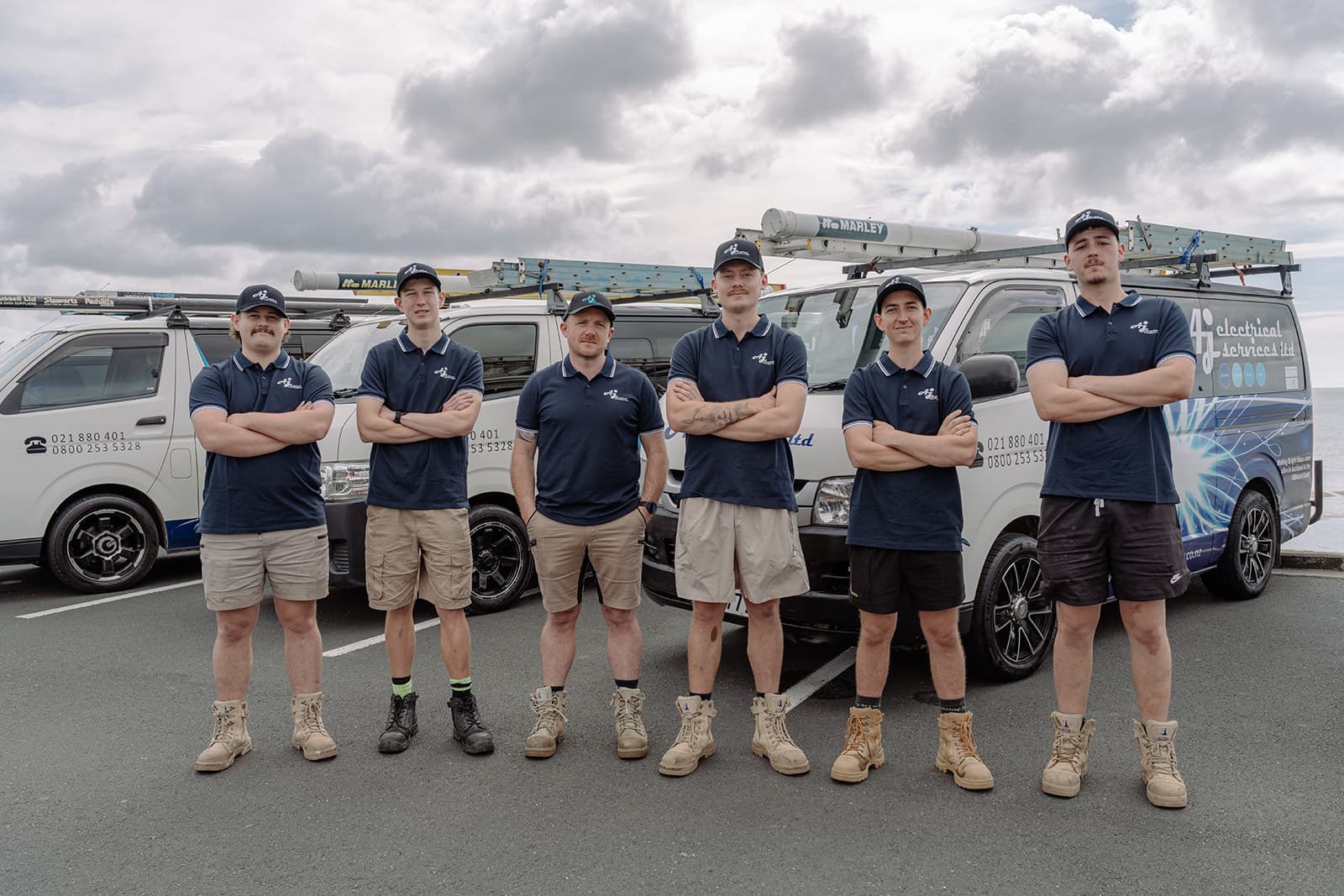 The AJ Electrical team in front of their vans